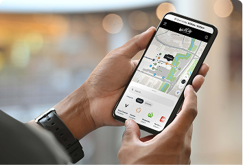 Close up of a person on the phone looking at the WestCity Waitakere centre map.